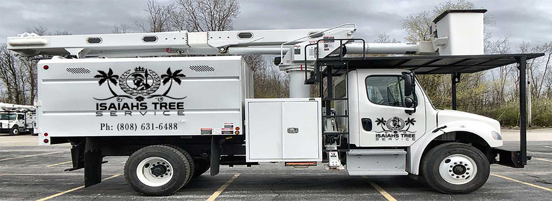 White tree trimming bucket truck in a parking lot with Isaiah's Tree Service logo on the side.